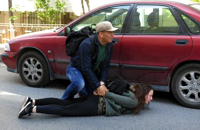 A plain clothes police officer detains a leftist protester during clashes, after the office of Istanbul's Governor banned the concert of left-wing band Grup Yorum in Istanbul April 12, 2015. (Photo by Yagiz Karahan/Reuters)