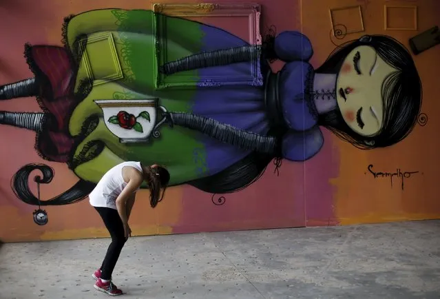 A girl looks at a work by Brazilian artist Sipros during the 3th International Biennial Fine Art Graffiti exhibition at the Ibirapuera park in Sao Paulo April 21, 2015. (Photo by Nacho Doce/Reuters)