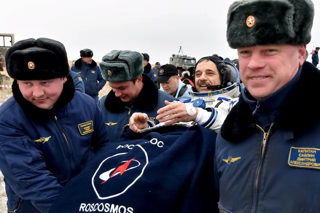 Ground personnel carry Russian cosmonaut Mikhail Korniyenko shortly after landing near the town of Dzhezkazgan (Zhezkazgan), Kazakhstan, March 2, 2016. (Photo by Kirill Kudryavtsev/Reuters)