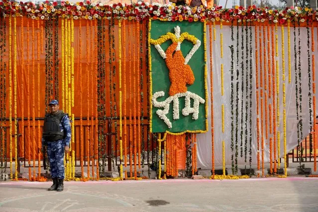 A Rapid Action Force (RAF) member guards a street during the inauguration of the Hindu Lord Ram temple on a big screen, in Ayodhya, India on January 22, 2024. (Photo by Adnan Abidi/Reuters)