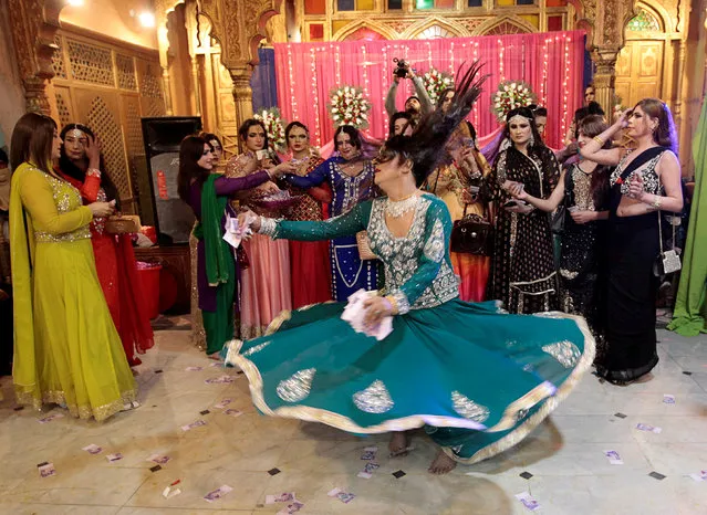 Members of the transgender community attend Shakeela's party in Peshawar, Pakistan on January 22,  2017. At a party in Peshawar, the guests' saris twirled as they danced to the music and fed each other pieces of cake, but armed police guarding the door indicated this was no normal carefree birthday gathering. The revellers were transgender, people who run the risk of violence in conservative Muslim Pakistan where they often work as dancers at weddings and other parties but are rarely allowed to hold their own celebrations. (Photo by Caren Firouz/Reuters)