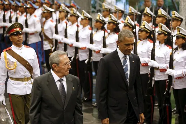 Cuban President Raul Castro (2nd L) and U.S. President Barack Obama (R) review Cuban soldiers during a welcome ceremony for Obama at the “Palacio de la Revolucion” in Havana, March 21, 2016. (Photo by Jonathan Ernst/Reuters)
