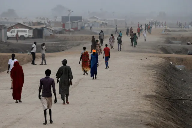 People walk on a road in the United Nations Mission in South Sudan (UNMISS) Protection of Civilian site (CoP), near Bentiu, northern South Sudan, February 8, 2017. (Photo by Siegfried Modola/Reuters)