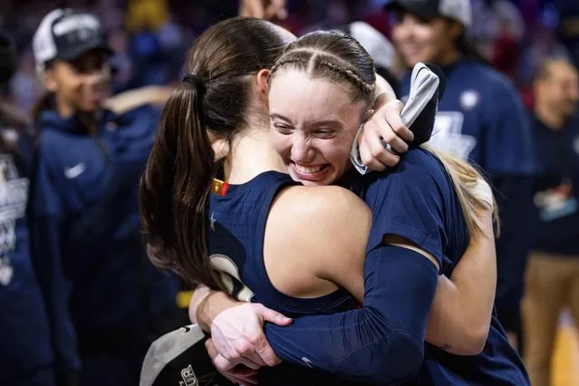 UConn guard Paige Bueckers, right, hugs guard Nika Muhl after their win over Southern California in an Elite Eight college basketball game in the women's NCAA Tournament, Monday, April 1, 2024, in Portland, Ore. (Photo by Howard Lao/AP Photo)