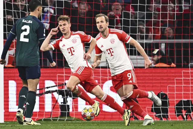 Bayern's Joshua Kimmich, center, and Harry Kane (9) celebrate after Kimmich scored during the Champions League quarter final second leg soccer match between Bayern Munich and Arsenal at the Allianz Arena in Munich, Germany, Wednesday, April 17, 2024. (Photo by Tom Weller/dpa via AP Photo)