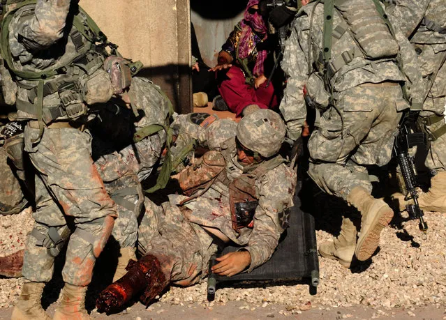 Paratroopers from Bravo Company 2/508th Parachute Infantry Regiment put a wounded Soldier on a litter for evacuation after a simulated attack on an Afghan village at the National Training Center at Fort Irwin, Calif., September 15, 2011. NTC is the final training evolution for many Army units prior to deploying into their specific area of operations. (Photo by Staff Sgt. Ashley M Hyatt/U.S. Army)