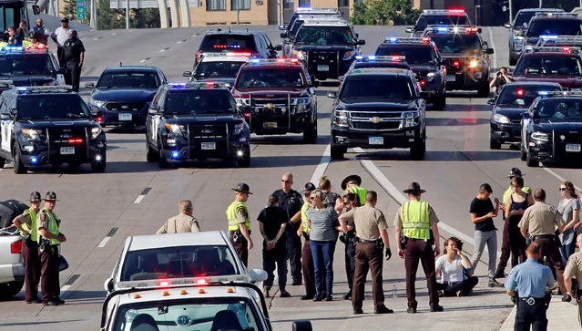 Protestors block the southbound lane of Interstate 35W in protest of the killing of Philando Castile in Minneapolis, Minnesota, U.S., July 13, 2016. Castile was fatally shot by police July 6, 2016. (Photo by Eric Miller/Reuters)