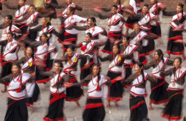 A group of the Newari community performs a traditional musical dance at the Nyatapole temple premises in Bhaktapur, Nepal, 08 April 2024, ahead of the Biska Jatra, the Nepali New Year festival. The “Biska Jatra” is celebrated in the hope of protection from all natural calamities and support for a good harvest for the coming year, which marks 2081 in the Nepali calendar, especially by the ethnic Newar communities in Bhaktapur. (Photo by Narendra Shrestha/EPA/EFE)
