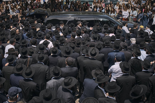People walk and touch the coffin during the funeral procession of Rabbi Moshe Kotlarsky, Vice Chairman of Merkos L'Inyonei Chinuch—the educational arm of the Chabad-Lubavitch movement—and Director of the annual International Conference of Chabad-Lubavitch Emissaries on Wednesday, June 5, 2024, in the Brooklyn borough of New York. Rabbi Moshe passed away on Tuesday, June 4th, 2024. He was only four days shy of his 75th birthday. (Photo by Andres Kudack/AP Photoi)