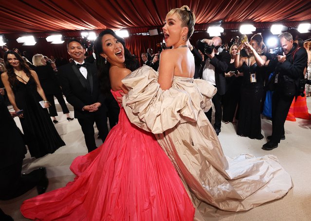 American actress Stephanie Hsu and English actress Florence Pugh pose on the champagne-colored red carpet during the Oscars arrivals at the 95th Academy Awards in Hollywood, Los Angeles, California, U.S., March 12, 2023. (Photo by Mario Anzuoni/Reuters)