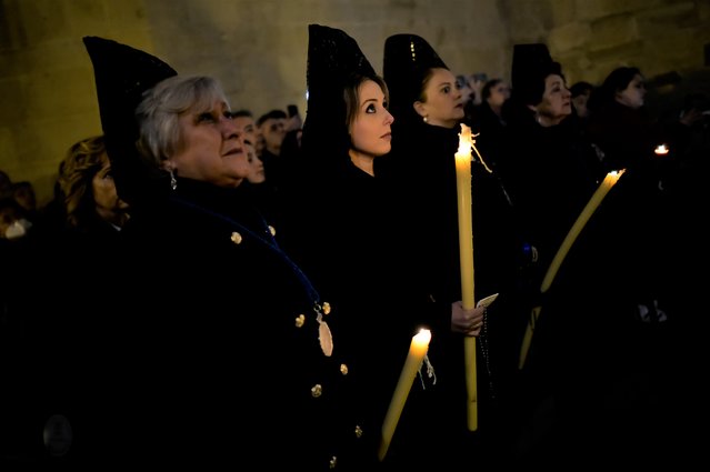 Devotes known as “Las Manolas”, hold candles while taking part in the Holy Monday procession in Logrono, northern Spain, Monday, April 3, 2023. (Photo by Alvaro Barrientos/AP Photo)