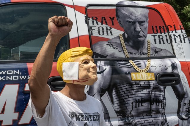 A person wears a Donald Trump mask as people line up to see Republican presidential nominee, former U.S. President Donald Trump speak on July 31, 2024 in Harrisburg, Pennsylvania. Trump is returning to Pennsylvania for the first time since the assassination attempt. Polls currently show a close race with Democratic presidential candidate, U.S. Vice President Kamala Harris. (Photo by Stephanie Keith 100584/Getty Images)