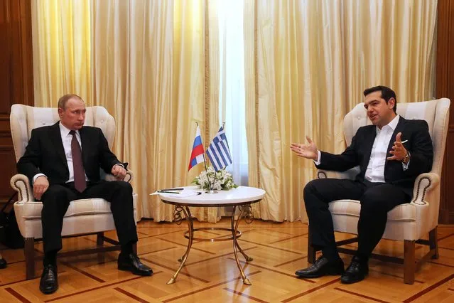 Greek Prime Minister Alexis Tsipras, right, speaks to Russian President Vladimir Putin during their meeting at the Maximos Mansion in Athens, Friday, May 27, 2016. Russian President Vladimir Putin made his first trip to a European Union country this year Friday with a visit to Greece that will include a stop at a secluded Christian Orthodox monastic sanctuary in the country's north. (Photo by Orestis Panagiotou/EPA via AP Photo)