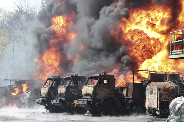 Vehicles are on fire at an oil depot after missiles struck the facility in an area controlled by Russian-backed separatist forces in Makiivka, 15 km (94 miles) east of Donetsk, eastern Ukraine, Wednesday, May 4, 2022. (Photo by AP Photo/Stringer)