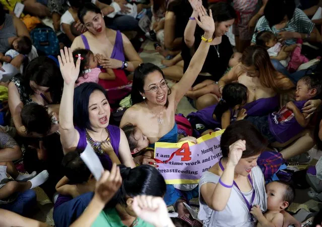 Mothers chant slogan “Hakab Na” (local term for breastfeeding) as they breastfeed their children in Mandaluyong city, Metro Manila in the Philippines August 1, 2015. (Photo by Erik De Castro/Reuters)