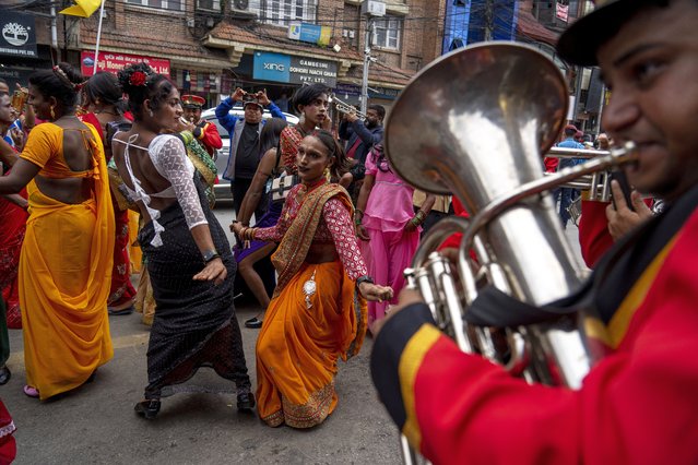 LGBTQ+ people and their supporters dance and rally during the annual pride parade, in Kathmandu, Nepal, Tuesday, August 20, 2024. (Photo by Niranjan Shrestha/AP Photo)