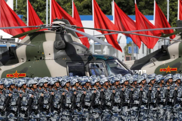Chinese soldiers stand by as Chinese President Xi Jinping inspects the troops of People's Liberation Army (PLA) Hong Kong Garrison at the Shek Kong Barracks in Hong Kong, Friday, June 30, 2017. (Photo by Kin Cheung/AP Photo)