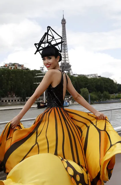 Vietnamese fashion show organiser, producer and model Jessica Minh Anh presents a creation during a fashion show on a tourist river boat cruising the Seine, as part of the J Autumn Fashion Show 2016 on June 15, 2016 near the Eiffel Tower in Paris. (Photo by Francois Guillot/AFP Photo)