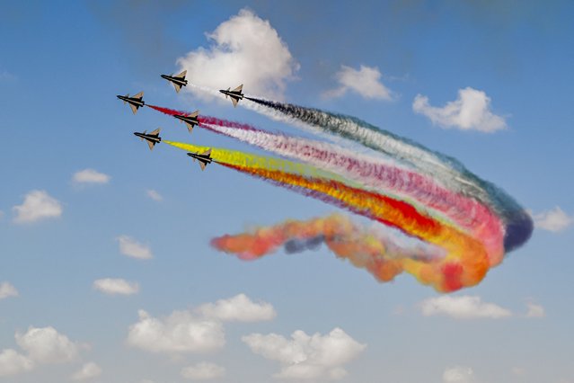 Chengdu J-10 Vigorous Dragon fighter aircraft of China's Ba Yi (August 1st) Aerobatics Team release smoke while performing manoeuvres during the first Egypt International Airshow at Alamein International Airport in Alamein in northern Egypt on September 4, 2024. (Photo by Khaled Desouk/AFP Photo)