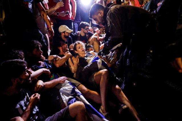 Protesters scuffle with police, during a demonstration, following a parliament vote on a contested bill that limits Supreme Court powers to void some government decisions, near the Knesset, Israel's parliament in Jerusalem on July 24, 2023. (Photo by Amir Cohen/Reuters)