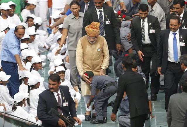 A school boy takes blessings from Indian Prime Minister Narendra Modi (C, wearing turban) in front of the historic Red Fort during Independence Day celebrations in Delhi, India, August 15, 2015. Modi sought to shed an image that he governs for big business on Saturday, vowing to help the poor in an annual speech aimed at bolstering popularity rather than tackling setbacks to his economic reform plans. (Photo by Adnan Abidi/Reuters)