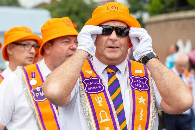 Orange Order members parade in Belfast on July 12, 2022 for the 12th July parades which take place across Northern Ireland to celebrate the battle of the Boyne in 1690, when the Protestant King William of Orange defeated the Catholic King James. (Photo by Paul Faith/AFP Photo)
