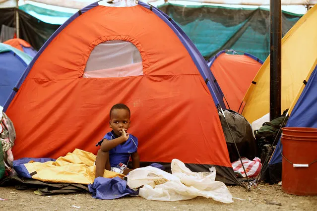 An African migrant children stranded in Costa Rica, sits outside his tent at makeshift camp at the border between Costa Rica and Nicaragua, in Penas Blancas, Costa Rica, July 14, 2016. (Photo by Juan Carlos Ulate/Reuters)