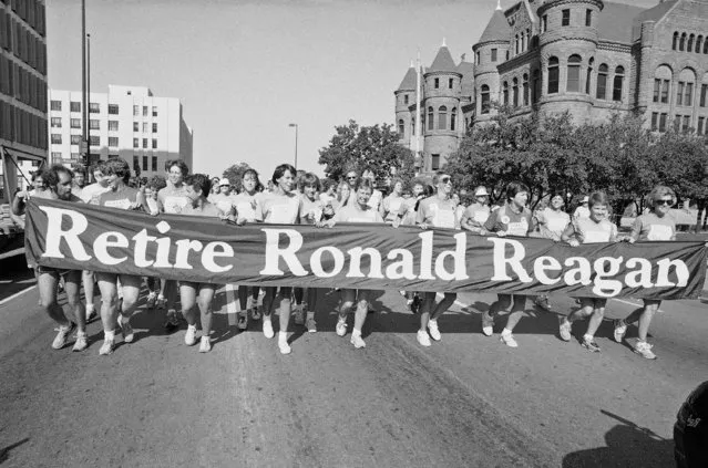 Demonstrators participating in a “Women Running Against Reagan” rally run down Dallas' Commerce Street in Dallas, on Saturday, August 18, 1984 with a banner reading: “Retire Ronald Reagan”. The Republican National Convention begins Monday. (Photo by Lana Harris/AP Photo)