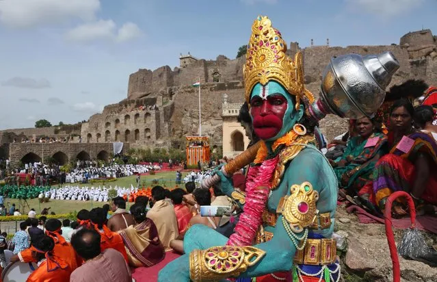 An Indian artist  dressed as Hindu monkey-God Hanuman waits to perform during independence Day celebrations at Golconda Fort in Hyderabad, India, Friday, August 15, 2014. India celebrates its 1947 independence from British colonial rule on August 15. (Photo by Mahesh Kumar A./AP Photo)