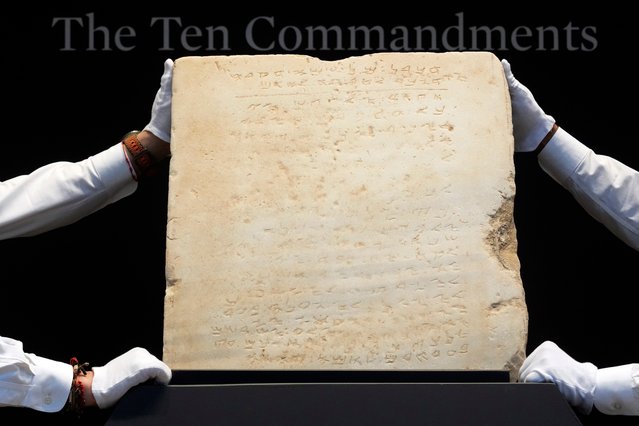 The oldest complete tablet of the Ten Commandments, weighing 115-pounds and approximately 1,500 years old, is displayed at Sotheby's, in New York, Monday, December 9, 2024, where it is to be offered for auction in a single lot sale, Dec, 18, 2024. (Photo by Richard Drew/AP Photo)