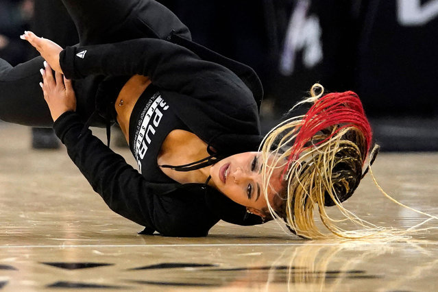 A San Antonio Spurs' dancer performs at halftime during the NBA preseason game between the San Antonio Spurs and Miami Heat at the AT&T Center in San Antonio, Texas, on October 13, 2023. (Photo by Timothy A. Clary/AFP Photo)