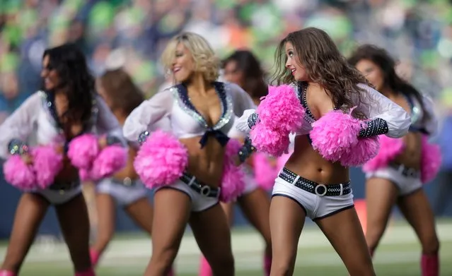 Seattle Seahawks Sea Gals cheerleaders perform with pink boots and pom poms for breast cancer awareness during an NFL football game between the Seattle Seahawks and the Tennessee Titans, Sunday, October 13, 2013, in Seattle. (Photo by Scott Eklund/AP Photo)