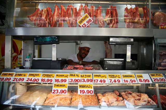 Jeymerson Pereira, a 25-year-old butcher, poses for a portrait in Rio de Janeiro, Brazil, July 19, 2016. When asked what he felt about Rio de Janeiro hosting the Olympics, Jeymerson said, “We don't need the Olympics, we need more schools and hospitals." He is also concerned that nothing will change for the poor in Rio de Janeiro, “We would need to change the government and start afresh”. (Photo by Pilar Olivares/Reuters)