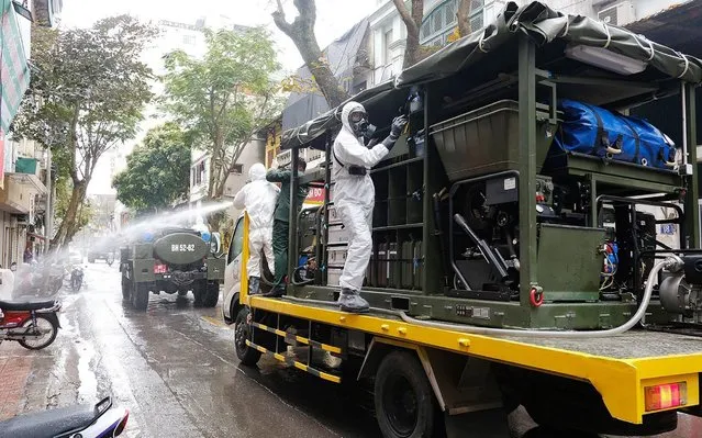 Soldiers from The High Command of Chemicals under Vietnam's Ministry of National Defence spray disinfectant as a precaution against the coronavirus on Truc Bach street in Hanoi, Vietnam, 07 March 2020. A 26-year-old Vietnamese woman recently back from Europe has tested positive for coronavirus, the first confirmed case after weeks. Since the outbreak began, the country has reported only 17 cases of COVID-19, 16 of whom have been cured and released from hospital. (Photo by EPA/EFE/Rex Features/Shutterstock/Stringer)