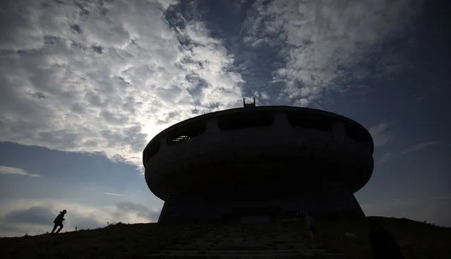 A man walks near the Memorial House of the Bulgarian Communist Party on mount Buzludzha September 12, 2014. (Photo by Stoyan Nenov/Reuters)