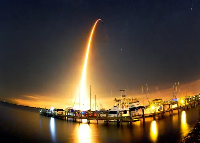 A SpaceX Falcon 9 rocket lights up the sky during liftoff at 1:52.03 a.m. Sunday morning September 21, 2014 for the resupply mission to the International Space Station photo taken at the Whitley Marina Cocoa. (Photo by  Craig Rubadoux/AP Photo/Florida Today)