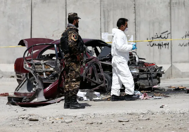 Afghan officials investigate at the site of a bomb blast near the U.S. Embassy in Kabul, Afghanistan August 15, 2016. (Photo by Mohammad Ismail/Reuters)