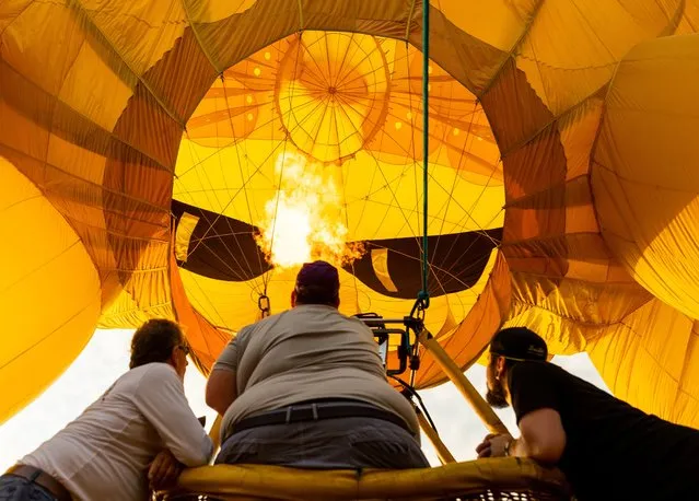Crews inflate hot air balloons during the 39th annual New Jersey Lottery Festival of Ballooning at Solberg Airport Friday, July 29, 2022, in Readington, N.J. (Photo by Julia Nikhinson/AP Photo)