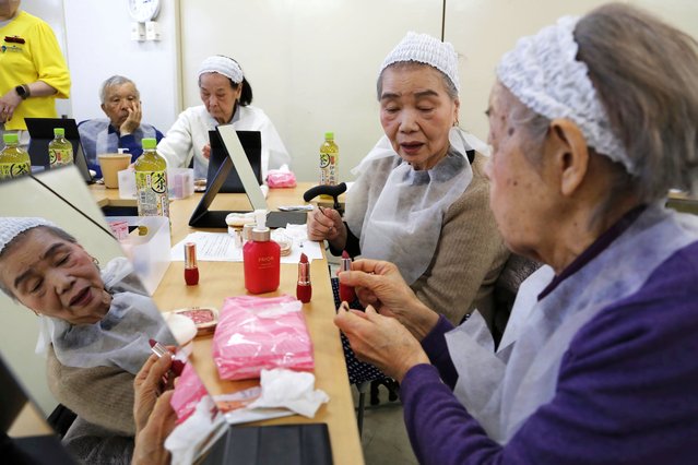 Participants try on makeup at a special class at a Tokyo housing complex that teaches people to stay healthy and beautiful, on February 14, 2025. (Photo by Yuri Kageyama/AP Photo)