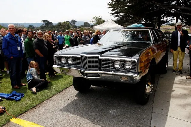 A 1972 Country Squire Wagon drives off the main stage during the Concours d'LeMons in Seaside, California, U.S. August 20, 2016. The Pebble Beach Concours d'Elegance is an automotive charitable event held each year on the Pebble Beach Golf Links in Pebble Beach, California, considered the most prestigious event of its kind. It is the finale of Monterey Car Week held in August every year. A Concours d'Elegance (French, literally “a competition of elegance”) is an event open to both prewar and postwar collector cars in which they are judged for authenticity, function, history, and style. (Photo by Michael Fiala/Reuters/Courtesy of The Revs Institute)