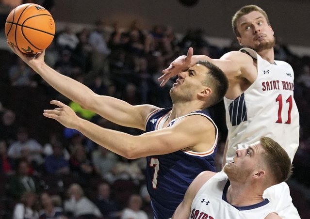 Pepperdine forward Stefan Todorovic (7) attempts to shoot around Saint Mary's forward Luke Barrett, bottom, and center Mitchell Saxen (11) during the first half of an NCAA college basketball game in the semifinals of the West Coast Conference tournament Monday, March 10, 2025, in Las Vegas. (Photo by John Locher/AP Photo)