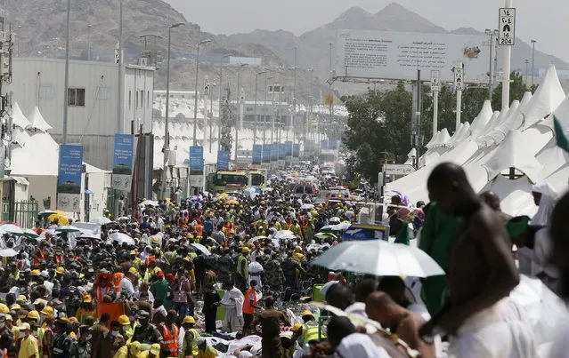 Muslim pilgrims and rescuers gather around the victims of a stampede in Mina, Saudi Arabia during the annual hajj pilgrimage on Thursday, September 24, 2015. (Photo by AP Photo)