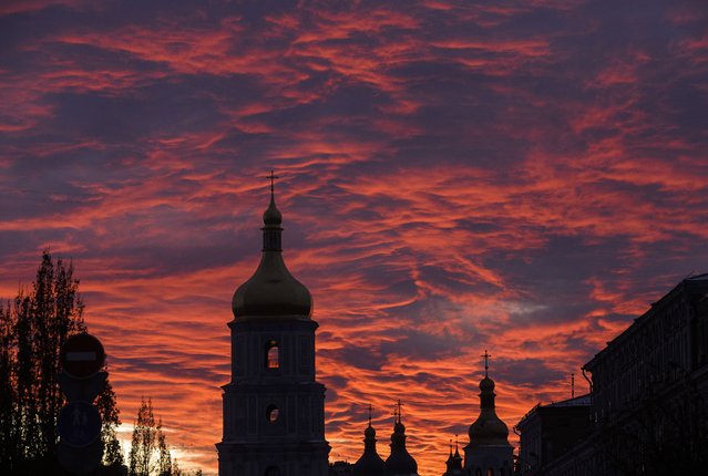 The sun sets above the St. Sophia Cathedral in downtown Kyiv, Ukraine, 14 January 2025. (Photo by Sergey Dolzhenko/EPA/EFE)