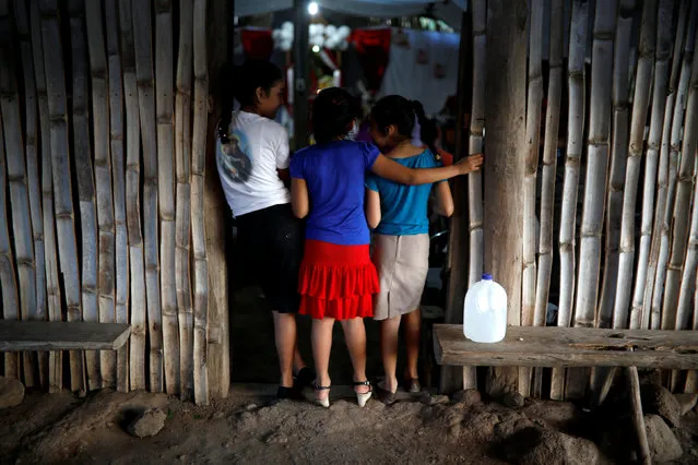 Girls participate in the wake of  the remains of six children, victims of El Mozote Massacre for a wake, during the 36th anniversary of the massacre, in the village of La Joya in Meanguera, El Salvador, December 9, 2017. (Photo by Jose Cabezas/Reuters)