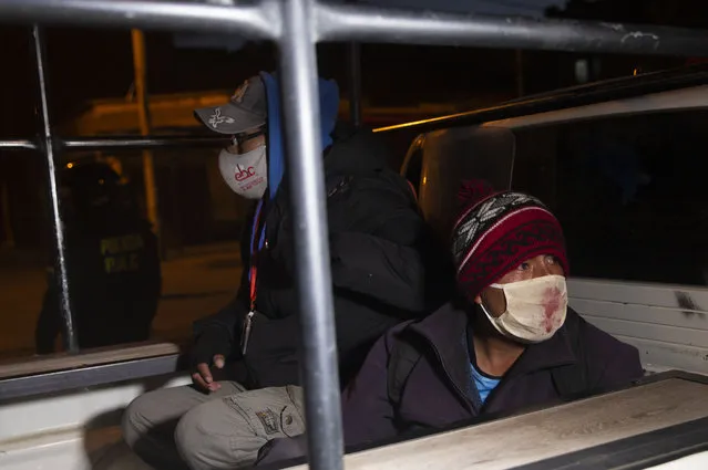 Detained demonstrators sit in the bed pf a police pick-up truck during a protest against the postponement of the upcoming presidential election in El Alto, Bolivia, Monday, August 10, 2020. Citing the ongoing new coronavirus pandemic, the nation's highest electoral authority delayed presidential elections from Sept. 6 to Oct. 18, the third time the vote has been delayed. (Photo by Juan Karita/AP Photo)
