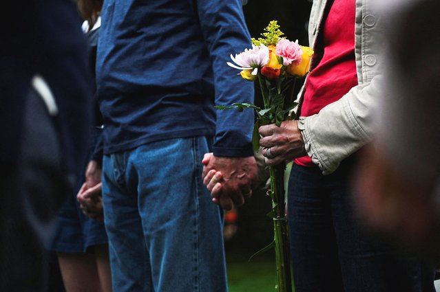Members of a church gather for prayer beside a memorial at the scene of an attack that injured multiple people, outside the Boulder County Courthouse, in Boulder, Colorado on June 2, 2025. (Photo by Mark Makela/Reuters)