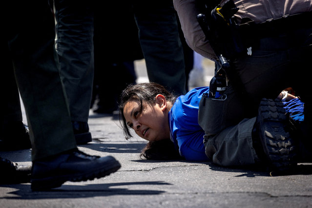 Los Angeles County Sheriff's deputies detain a woman during a standoff by protesters and law enforcement, following multiple detentions by ICE, in the Los Angeles County city of Paramount, California on June 7, 2025. (Photo by Barbara Davidson/Reuters)