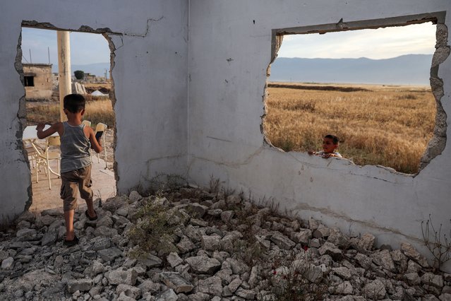 Children play in a destroyed house in the village of al-Hawash in Syria's west-central Hama province on May 22, 2025. Since Islamist forces ousted Assad after nearly 14 years of war, 1.87 million Syrians who were refugees abroad or internally displaced have returned to their areas of origin, the United Nations' International Organization for Migration says. (Photo by Omar Haj Kadour/AFP Photo)