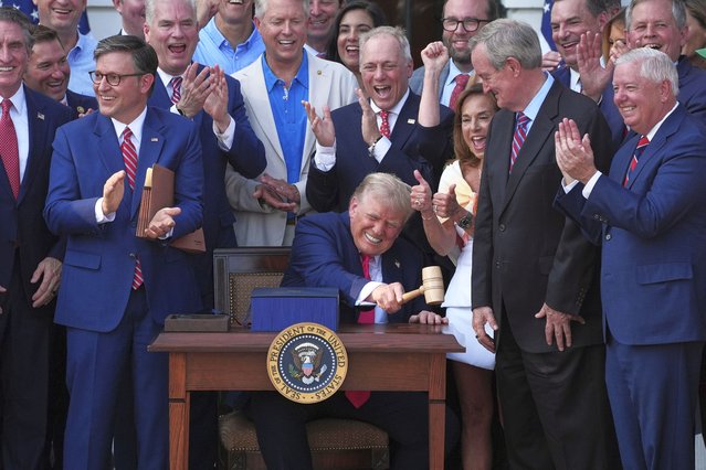 President Donald Trump pounds a gavel presented to him by House Speaker Mike Johnson after he signed his signature bill of tax breaks and spending cuts at the White House, Friday, July 4, 2025, in Washington. (Photo by Evan Vucci/AP Photo)