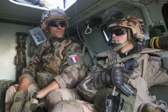 French soldiers from Operation Barkhane patrol in Timbuktu, November 5, 2014. If the French army and its allies are to keep al Qaeda at bay in the desert of northern Mali they must stop them seizing the biggest prizes in the sea of white sand - the wells.(Photo by Joe Penney/Reuters)
